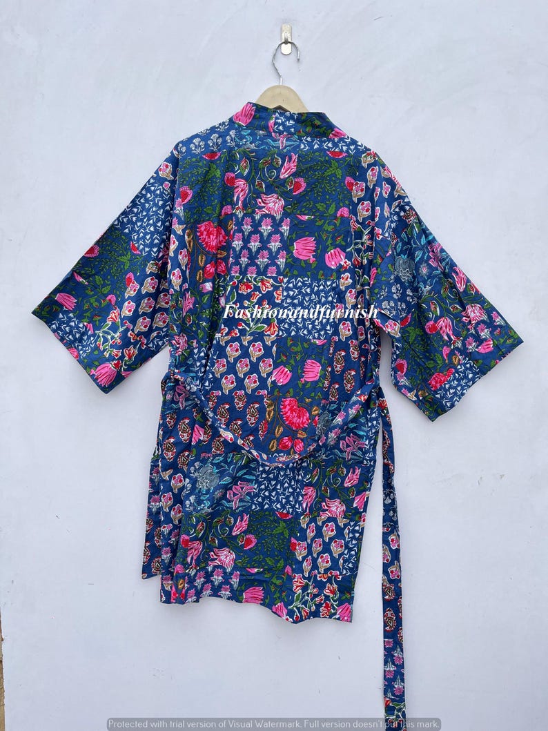 May include: A blue floral print kimono robe with a matching belt. The robe features a patchwork design with pink flowers and green leaves. The text "fashionandfurnish" is visible on the front of the robe.