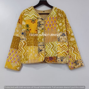 May include: A yellow quilted jacket with a patchwork design featuring various floral patterns. The jacket has a V-neck and a button closure. The text "FASHIONANDFURNISH" is visible on the front of the jacket.
