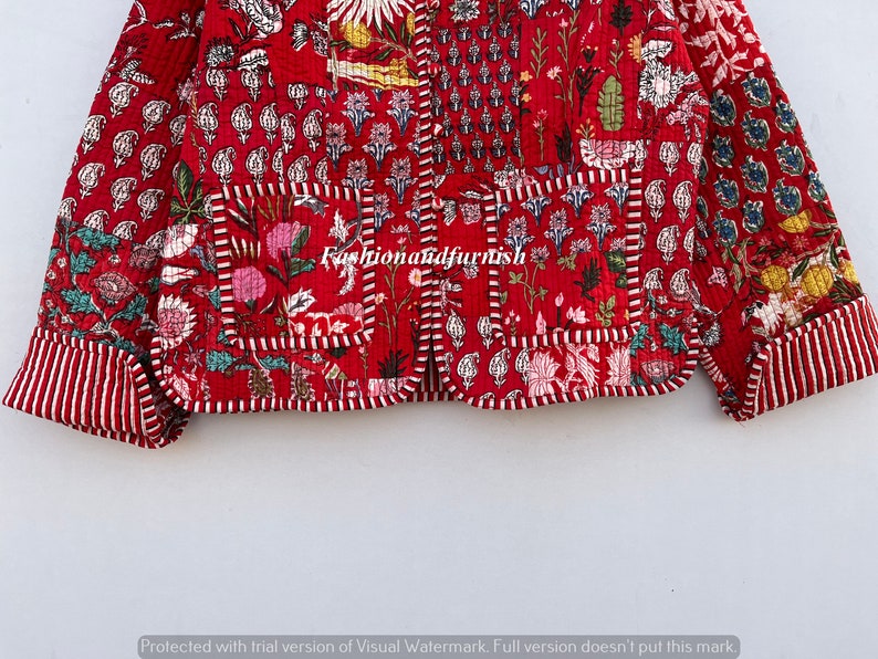 May include: A red quilted jacket with a floral print and a white trim. The jacket has a button closure and two pockets.