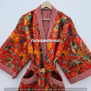May include: Red quilted robe featuring a floral and bird design. The robe has a striped collar and trim, a matching belt, and pockets. The text "Fashionandfurnish" is visible on the robe.