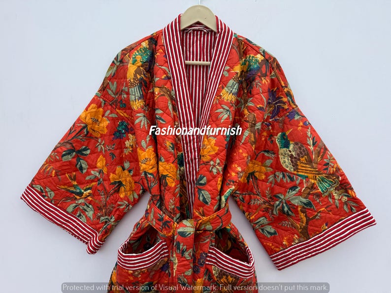 May include: Red quilted robe featuring a floral and bird design. The robe has a striped collar and trim, a matching belt, and pockets. The text "Fashionandfurnish" is visible on the robe.