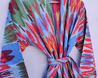 May include: A blue, red, green, and yellow patterned cotton robe with a tie belt and two pockets.