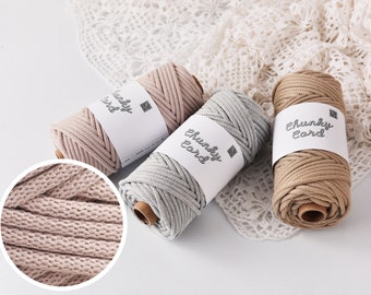May include: Three spools of chunky cord in beige, gray, and tan, each wrapped with a white label that reads "Chunky Cord". The cord is tightly wound, showing a textured pattern. A close-up shows the cord's woven detail.