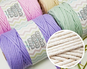 May include: A collection of colorful crochet rope spools in shades of blue, tan, pink, cream, green, and purple. Each spool is labeled with the text "Crochet Zigzag Rope Cotton 100%" in a white and green zig-zag pattern.