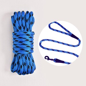 May include: A coiled blue rope with black accents and a matching blue leash with a metal clasp. The rope is tightly wound, and the leash has a loop handle. The items are set against a plain background.