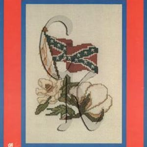 May include: A cross-stitch pattern booklet titled "Hurray for Dixie... Vol. 1" featuring a white magnolia flower, a green leaf, and a Confederate flag.
