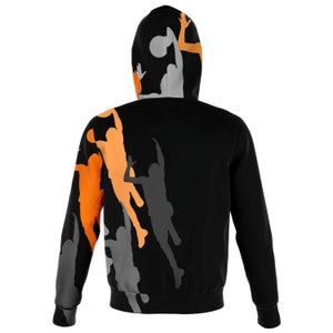 May include: Black zip-up hoodie with a basketball theme. The hoodie features silhouettes of basketball players in orange and gray on a black background.