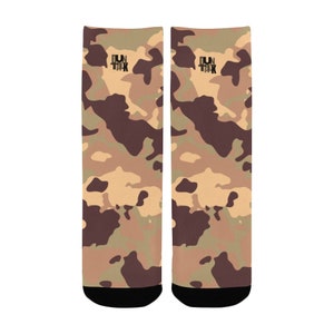 May include: A pair of brown, tan, and green camouflage socks with black accents. The socks have the text "DUN TALK" on the top of each sock.