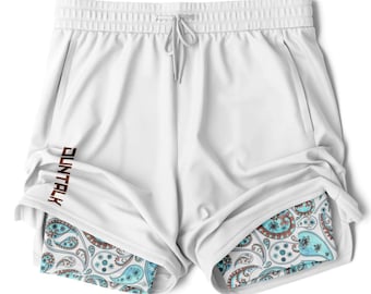 Könnte beinhalten: Weiße Sport Shorts mit einem Paisley-Muster-Futter. Die Shorts haben einen Kordelzugbund und das Wort "DUNTALK" ist seitlich aufgedruckt.