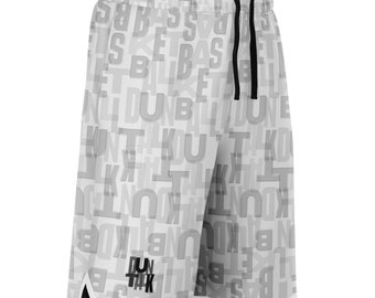 May include: White basketball shorts with a grey print of the words "basketball", "dunk", and "shoot" repeated all over. The shorts have a black drawstring and a black and white trim around the bottom.