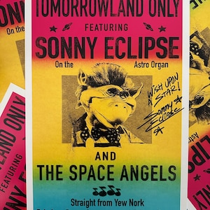 May include: A colorful poster with the text "Tomorrowland Only" featuring "Sonny Eclipse" and "The Space Angels." The poster has a retro design with a cartoon character and the words "Wish Upon a Star!" The background has a gradient of yellow, pink, and blue.
