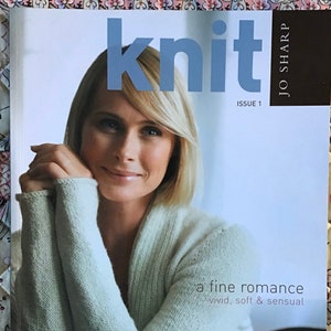 May include: Magazine cover with a woman in a light green cardigan. The title "knit" is in blue. Text includes "Issue 1", "a fine romance", and "35 hand knitting patterns". The magazine is by Jo Sharp.
