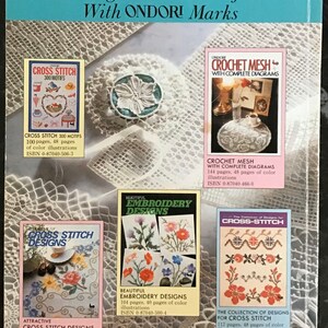 May include: A collection of handicraft books featuring cross-stitch, crochet mesh, and embroidery designs. The books have colorful illustrations and diagrams. The cover text reads "Best Selling New Handicraft Books With ONDORI Marks."