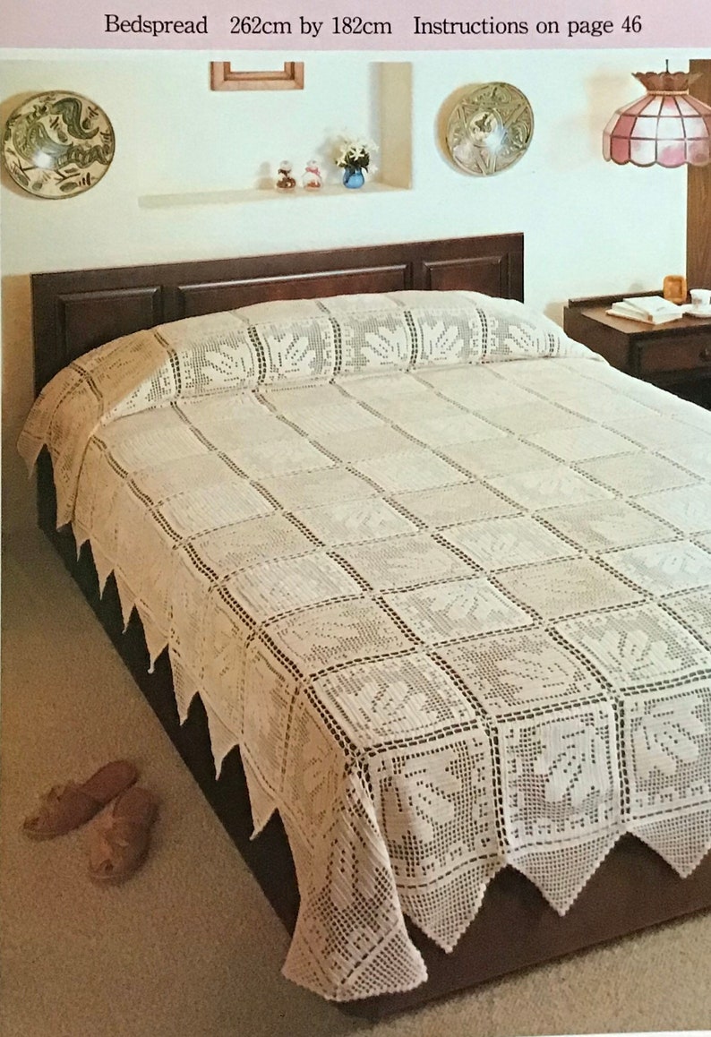 May include: A cream-colored, crocheted bedspread with a geometric pattern and leaf motifs. The bedspread measures 103 inches by 72 inches. The edges feature a scalloped trim. The text "Bedspread" is visible at the top of the image.