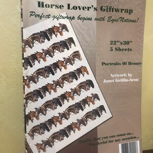 May include: A package of horse-themed gift wrap featuring a repeating pattern of horse portraits. The package is brown with white text that reads "Horse Lover's Giftwrap" and "Perfect giftwrap begins with Equi Notions!" The package also includes the dimensions "22"x30" 5 Sheets" and the text "Portraits of Beauty" and "Artwork by Janet Griffin-Scott".