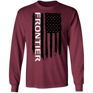 May include: A maroon long-sleeve t-shirt with a black and white American flag design and the word "FRONTIER" in white text.