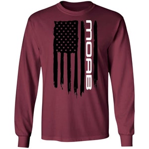 May include: A maroon long-sleeve t-shirt with a black and white American flag design and the word "MOAB" in white text.