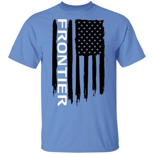 May include: A light blue t-shirt with a black and white American flag design. The word "FRONTIER" is printed vertically in white on the left side of the flag.