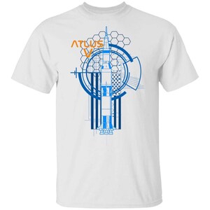 May include: A white short-sleeved t-shirt featuring a blue and orange graphic print of an Atlas V rocket. The design includes technical line art, a hexagonal grid pattern, circular radar-like elements, and a stylized American flag background.