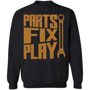 May include: Black sweatshirt with a distressed orange graphic that reads "Parts Fix Play" and a wrench graphic.