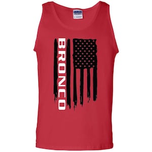 May include: Red sleeveless tank top with a black and white American flag design and the word "BRONCO" in white lettering.