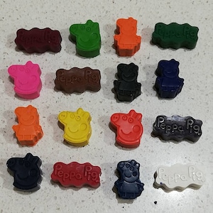 May include: Assortment of 15 Peppa Pig crayons in various colours, including red, orange, yellow, green, blue, pink, brown, and white. Each crayon features a Peppa Pig character design.