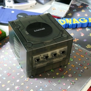 May include: A set of three ceramic mugs with a speckled, matte finish. The mugs are in shades of cream, light brown, and dark brown. Each mug has a simple, minimalist design, perfect for coffee or tea.