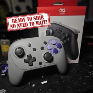 May include: A white ceramic mug with a black handle and the text "But First, Coffee" in a handwritten style. The mug is on a white surface. The mug is 4 inches tall.