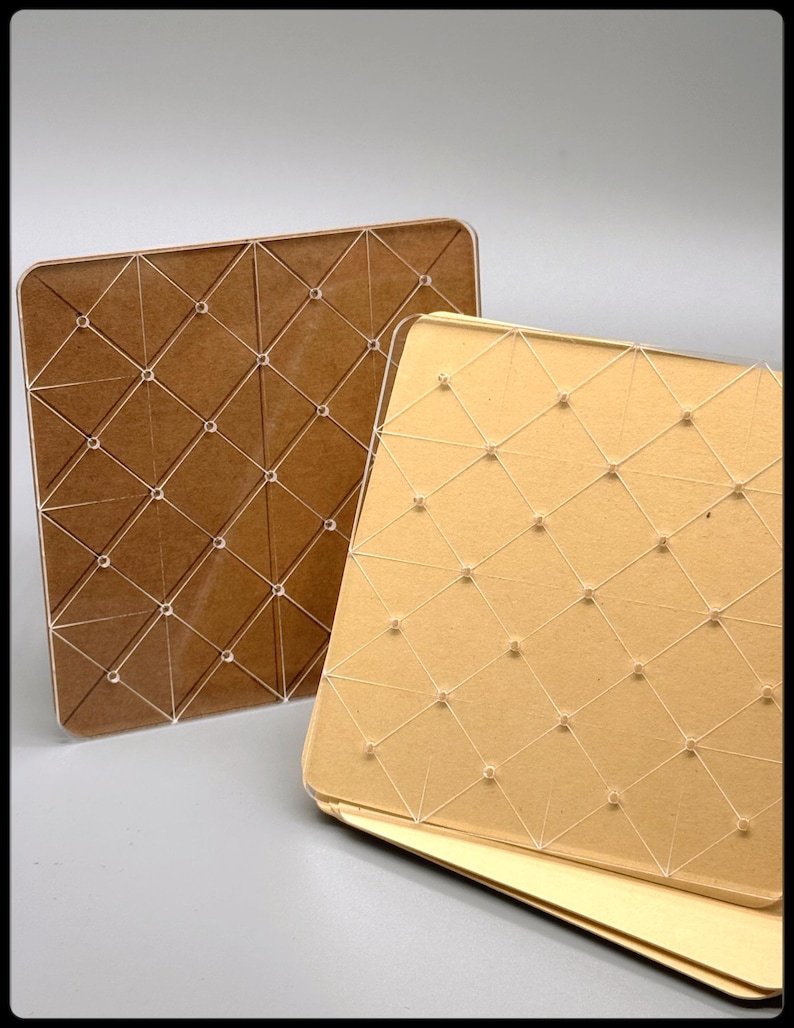 May include: Two square, decorative panels. One is a warm brown color, the other is a light gold. Both have a geometric pattern of intersecting lines and small, clear, round accents. The panels are likely for home decor or craft projects.