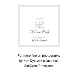 May include: A square graphic featuring a light blue border and a central illustration of a lifeguard tower labeled with the number 5. Below the tower, the text reads Salt Creek Prints, Fine Art Photography by Kim Dybczak. Below the square, text reads For more fine art photography by Kim Dybczak please visit SaltCreekPrints.com.