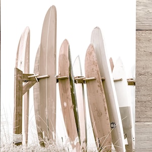 This is a sepia vertical photograph wall art print of surf boards at the iconic Hotel Del Coronado in San Diego, California. The sepia gives it a nostalgic feel.