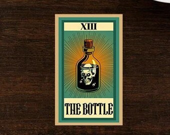 May include: A tarot card with a green background and a gold border. The card depicts a bottle with a skull inside. The card is labeled "XIII THE BOTTLE".