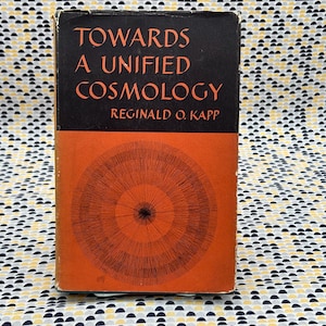 May include: A vintage hardcover book titled "Towards A Unified Cosmology" by Reginald O. Kapp. The cover features a red and black illustration of a circular pattern with concentric circles.