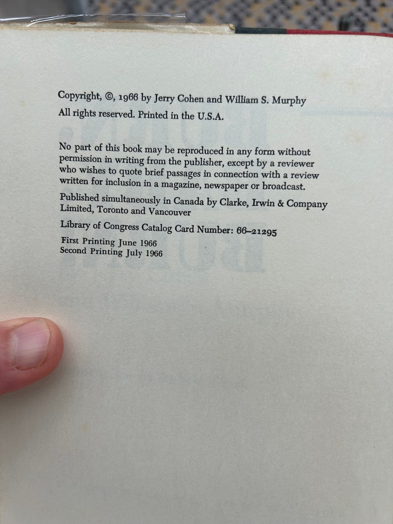 May include: Copyright information for a book published in 1966 by Jerry Cohen and William S. Murphy. The text states that all rights are reserved and the book was printed in the U.S.A. It also includes details about reproduction rights, publication details, and the Library of Congress Catalog Card Number: 66-21295. The text mentions the first and second printing dates: June 1966 and July 1966.