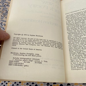 May include: A close-up of a book titled "Understanding the New Black Poetry" by Stephen Evangelist. The book cover is white with black text and includes the copyright information: Copyright 1972 by Stephen Henderson.