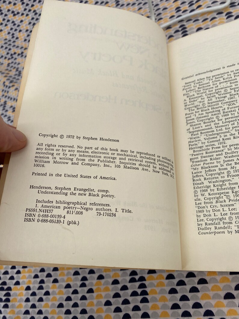 May include: A close-up of a book titled "Understanding the New Black Poetry" by Stephen Evangelist. The book cover is white with black text and includes the copyright information: Copyright 1972 by Stephen Henderson.
