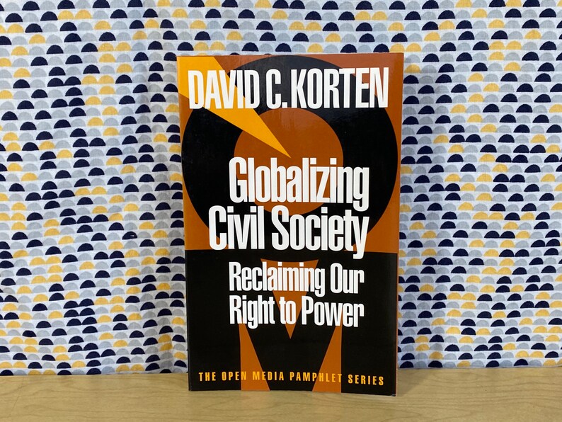 May include: A brown and black book with the title "Globalizing Civil Society: Reclaiming Our Right to Power" by David C. Korten. The book is part of the Open Media Pamphlet Series.