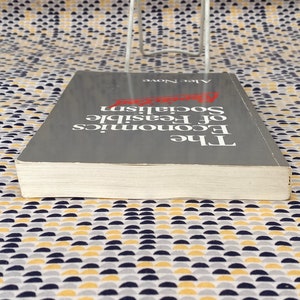 May include: A gray hardcover book titled "The Economics of Feasible Socialism" by Alec Nove.