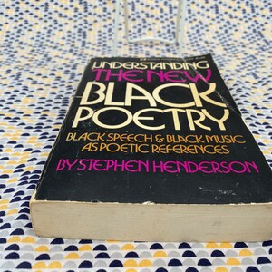 May include: A black book titled "Understanding the New Black Poetry" with the subtitle "Black Speech & Black Music as Poetic References" by Stephen Henderson.