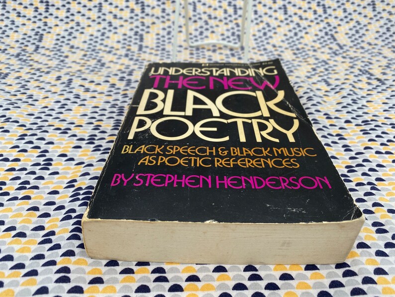 May include: A black book titled "Understanding the New Black Poetry" with the subtitle "Black Speech & Black Music as Poetic References" by Stephen Henderson.