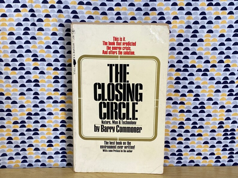 K&ouml;nnte beinhalten: Ein wei&szlig;es Buch mit goldfarbenem R&uuml;cken, betitelt "The Closing Circle: Nature, Man & Technology by Barry Commoner". Der Buchumschlag zeigt schwarzen Text und einen goldenen Rahmen.