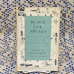 May include: A vintage paperback book titled "Black Elk Speaks: Being the Life Story of a Holy Man of the Oglala Sioux" by John G. Neihardt (Flaming Rainbow). The cover features a blue background with illustrations of Native American figures and animals.