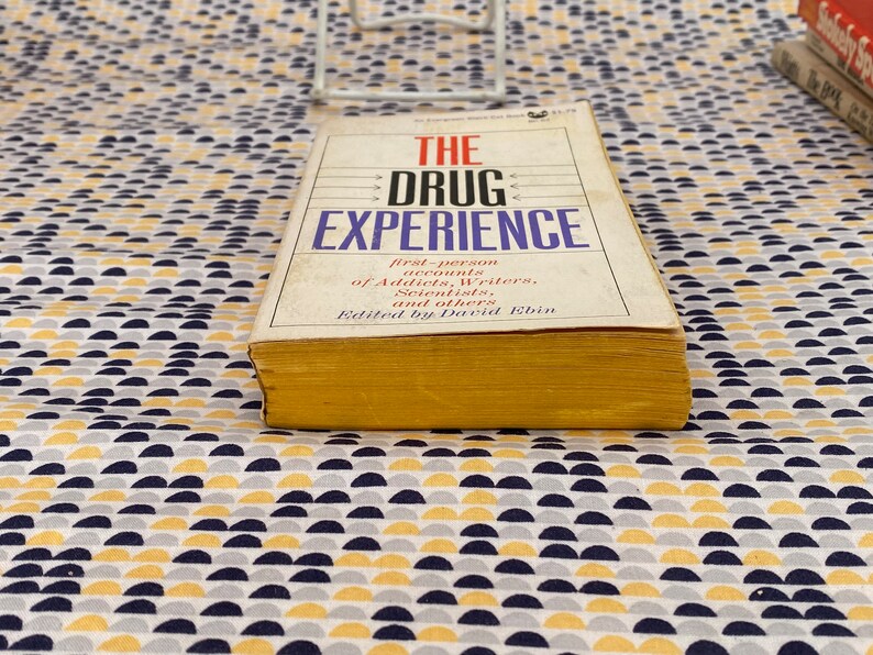 May include: A yellow and white book titled "The Drug Experience: First-person accounts of Addicts, Writers, Scientists, and others. Edited by David Ebin."