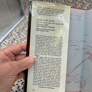 May include: A book cover with a black and white photo of a burning car and a title that reads "Burn, Baby, Burn! The Los Angeles Race Riot August, 1965" by Jerry Cohen and William S. Murphy. The book cover also includes a map of Los Angeles.