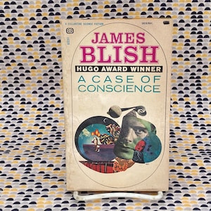 May include: Vintage paperback book titled "A Case of Conscience" by James Blish. The cover features a retro design with the author's name in pink and the title in teal. A collage of images and a portrait are also on the cover.