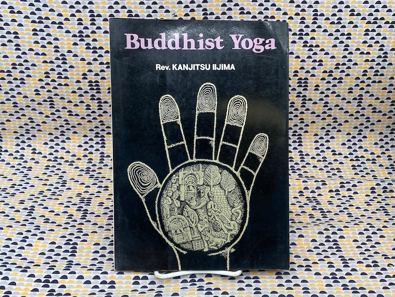May include: A black book with the title "Buddhist Yoga" and the author "Rev. KANJitsu IIJIMA" in white text. The cover features a black and white illustration of a hand with a circle in the palm.