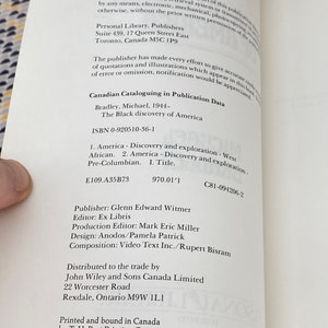 May include: Open book page with copyright information and text about "The Black Discovery of America" by Michael Bradley. The text includes the ISBN, publisher, and other publication details. The page is white with black text.