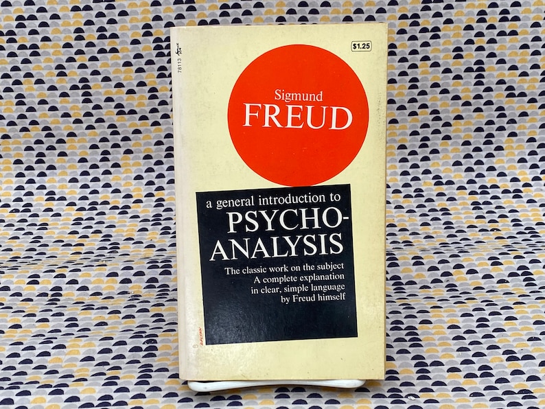 May include: A vintage paperback book with a red circle on the cover that says "Sigmund FREUD" in white text. The title of the book is "a general introduction to PSYCHO-ANALYSIS". The book is by Sigmund Freud and is a classic work on the subject of psychoanalysis.