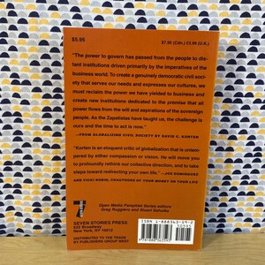 May include: The back cover of a book titled "Globalizing Civil Society" by David C. Korten. The cover is orange with black text and a barcode. The book is published by Seven Stories Press and distributed by Publishers Group West.