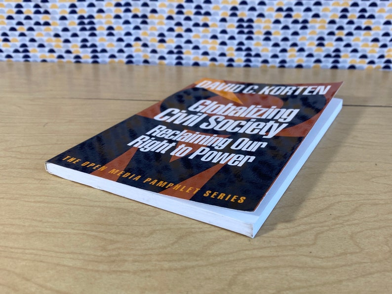 May include: A paperback book titled "Globalizing Civil Society: Reclaiming Our Right to Power" by David C. Korten. The book cover features a black and orange design with the title in white text.